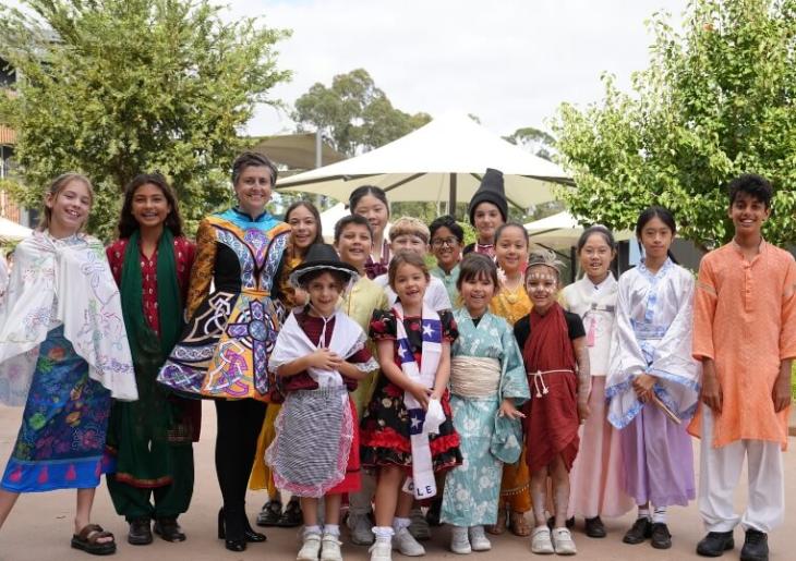 Junior School students dress in cultural attire standing together 