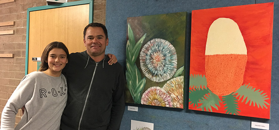 Dad-and-daughter-with-two-paintings-of-flowers