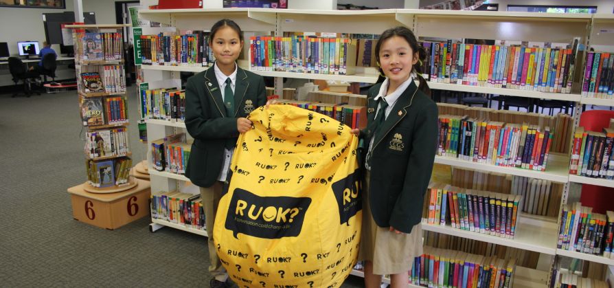 Two_students_holding_ruok_beanbag