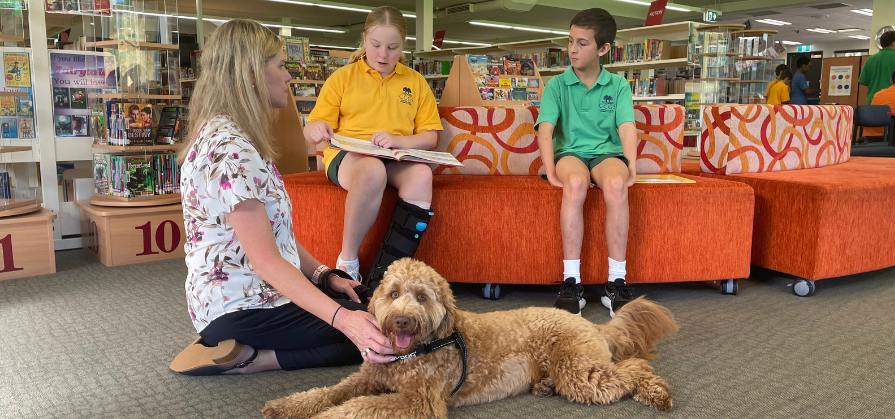 Sunny reading with the children in the Library