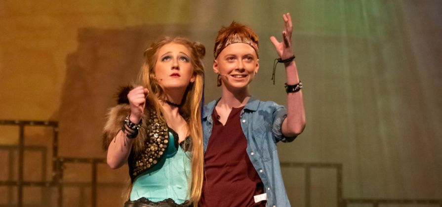 Two students acting on stage