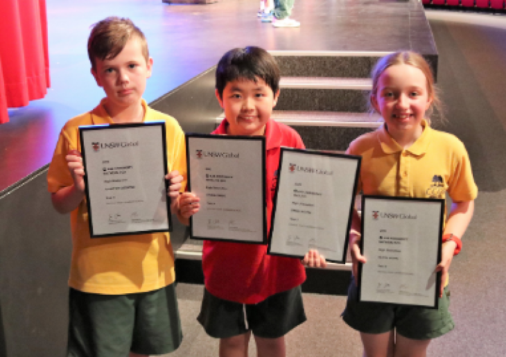 Junior-school-students-holding-awards