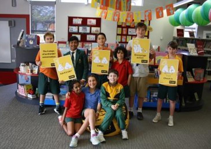 Children_standing_together_holding_RUOK_signs